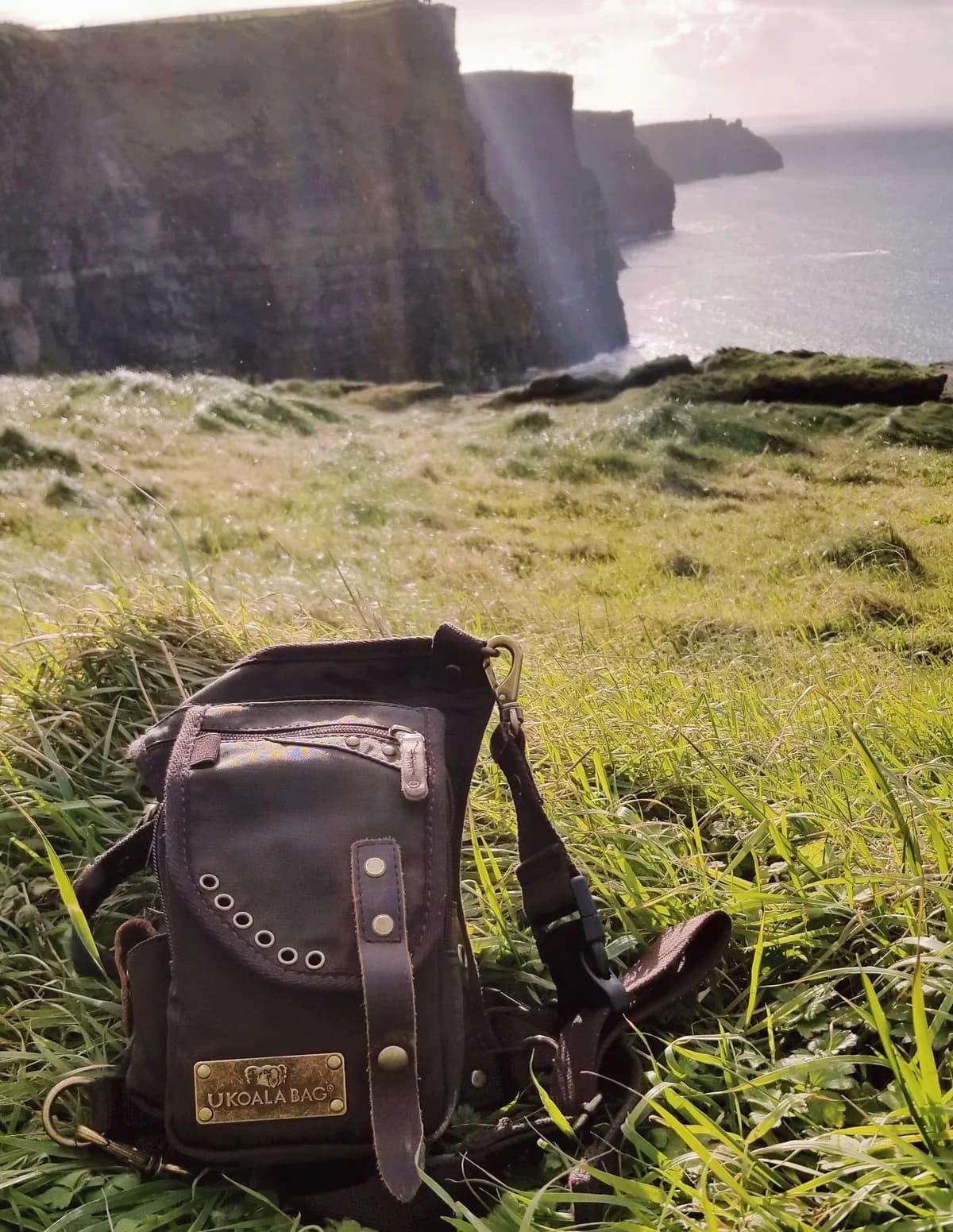 Ukoala bag resting in the grass above the Cliffs of Moher in Ireland